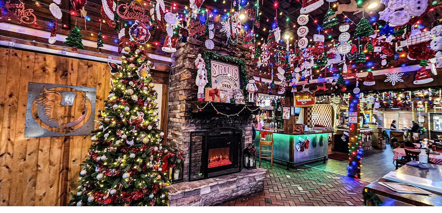 Immersive Christmas popup décor with a lit tree and fireplace inside a host restaurant